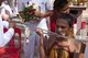 Thailand: Devotees or 'ma song' returning from the parade have their chosen implements removed from their faces, San Chao Chui Tui (Chinese Taoist temple), Phuket Vegetarian Festival