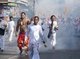Thailand: Devotees or 'Ma Song' and shrine bearers race through the streets to avoid exploding firecrackers, Phuket Vegetarian Festival