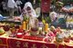 Thailand: A woman at a street altar awaits the procession of entranced devotees or 'Ma Song', Phuket Vegetarian Festival