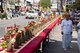 Thailand: A woman at a long street altar awaits the procession of entranced devotees or 'Ma Song', Phuket Vegetarian Festival