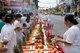 Thailand: People at a long street altar await the procession of entranced devotees or 'Ma Song', Phuket Vegetarian Festival